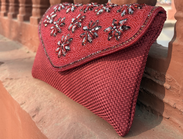 Red embellished clutch bag